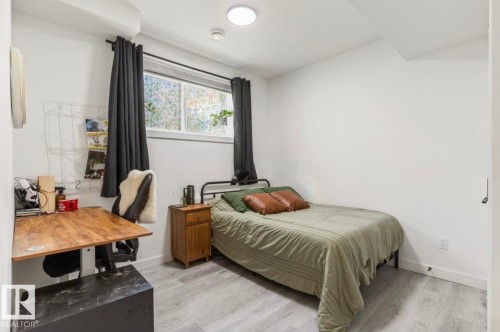 Room featuring light gray wood-finish flooring and white walls - 19703 29 Avenue, Edmonton, AB 