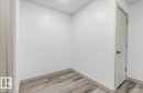 Neutral wall finishes with a modern door featuring a matte black handle - Edmonton, AB 