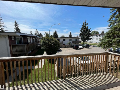 Private balcony featuring natural wood railings and a planked floor - 8930B 144 Avenue, Edmonton, AB 