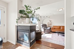 Corner gas fireplace with a white mantel and glass enclosure - 