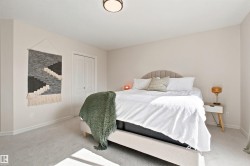 Carpeted room featuring a ceiling-mounted light fixture, light-toned walls, and white trim - 