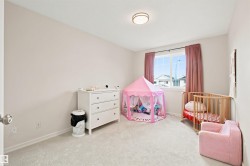 Carpeted room with a ceiling-mounted light fixture, neutral wall paint, and a double-hung window - 