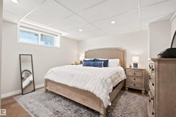 Bedroom featuring wood-finish flooring, recessed lighting, and a drop ceiling - 