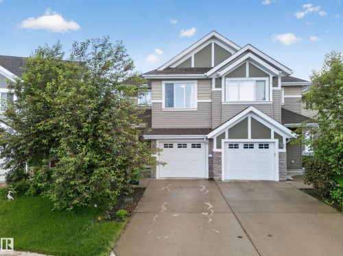 Modern multi-level exterior with gabled roof lines and contrasting siding - 2155 67 Street, Edmonton, AB 