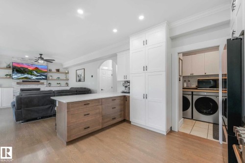 Central kitchen island with a light-toned wood-finish base and a light-colored countertop - 553006 Range Road 153, Rural Two Hills County, AB - Indoor Photo Showing Other Room