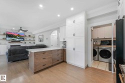 Central kitchen island with a light-toned wood-finish base and a light-colored countertop - 