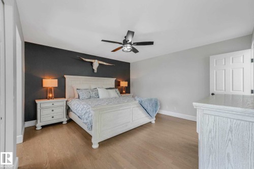 Light wood-finish flooring complements the neutral wall tones - 553006 Range Road 153, Rural Two Hills County, AB - Indoor Photo Showing Bedroom