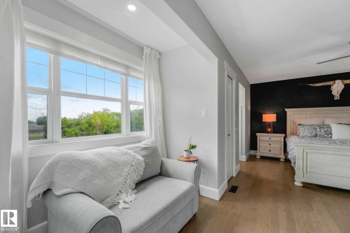 Bedroom featuring light wood-finish flooring, a distinct accent wall, and recessed lighting - 553006 Range Road 153, Rural Two Hills County, AB - Indoor Photo Showing Bedroom