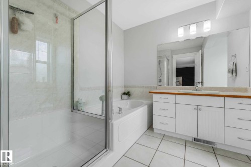 White tile flooring and a corner soaking tub and large shower - 553006 Range Road 153, Rural Two Hills County, AB - Indoor Photo Showing Bathroom
