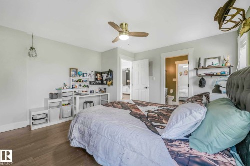 Light-filled interior space featuring wood-finish flooring, a ceiling fan with integrated lighting, and an open doorway leading to an additional space - 553006 Range Road 153, Rural Two Hills County, AB - Indoor Photo Showing Bedroom