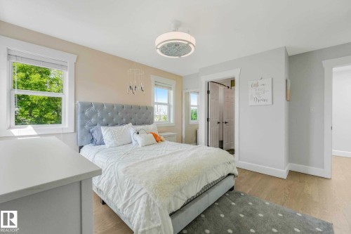 Bright room featuring wood-finish flooring and multiple windows - 553006 Range Road 153, Rural Two Hills County, AB - Indoor Photo Showing Bedroom