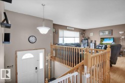Foyer entry with a white paneled door featuring an arched transom window and sidelight - 