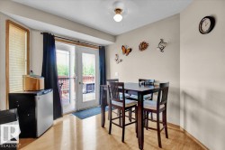 French doors opening to an exterior deck, complemented by wood-finish flooring and a bay window - 