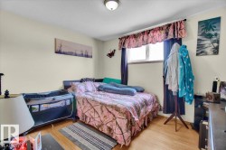 Room featuring a single window, overhead flush mount lighting, and wood-finish flooring - 