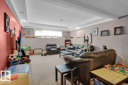 Spacious lower-level room featuring recessed lighting, a drop ceiling, and light-colored carpeting - 5506 53St, Mundare, AB 