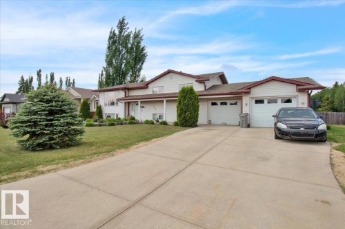 Two-story residence featuring light-toned siding and a brown-trimmed roofline - 5506 53St, Mundare, AB 