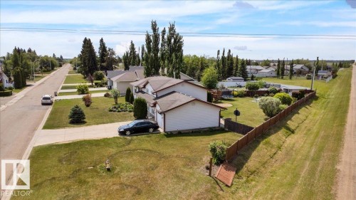 Suburban residence featuring a multi-car driveway, attached garage, and a fenced backyard - 5506 53St, Mundare, AB 