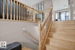 Light wood-finish staircase featuring turned balusters and a complementary handrail - 