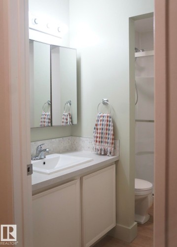Bathroom vanity featuring a single basin sink and chrome faucet - 25 8930 99 Avenue, Fort Saskatchewan, AB 