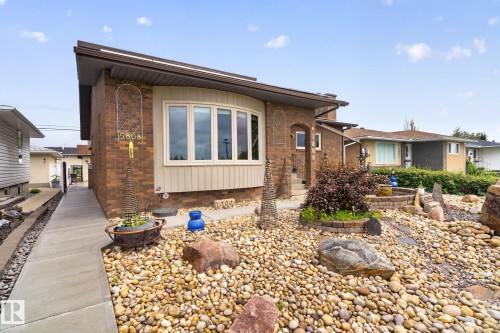 Brick exterior featuring a bay window with light-toned siding - 5808 Austin O'Brien Road, Edmonton, AB 