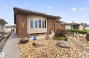 Brick exterior featuring a bay window with light-toned siding - 5808 Austin O'Brien Road, Edmonton, AB 