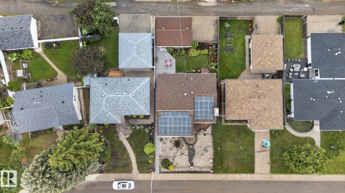 Aerial perspective of a property featuring a brown shingle roof with integrated solar panels - 5808 Austin O'Brien Road, Edmonton, AB 