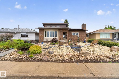 Brick exterior featuring a prominent bay window with white trim - 5808 Austin O'Brien Road, Edmonton, AB 