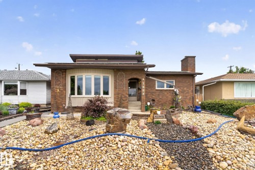 Brick facade home featuring a prominent bay window with white trim - 5808 Austin O'Brien Road, Edmonton, AB 