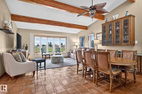 Vaulted ceilings featuring exposed wood beams, a bay window, and parquet wood-finish flooring - 5808 Austin O'Brien Road, Edmonton, AB 