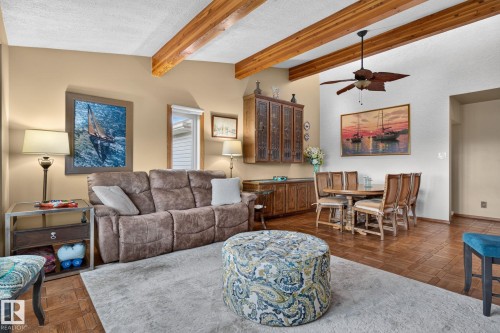 Vaulted ceiling with wood beams and a ceiling fan, complemented by recessed lighting - 5808 Austin O'Brien Road, Edmonton, AB 