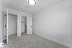 Room featuring light grey carpet flooring, white painted walls, and white baseboards - 