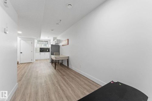 Open-concept living area with wood-finish flooring - 3606 42 Avenue, Beaumont, AB 