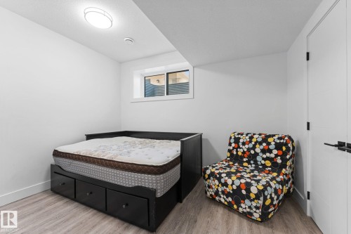 Neutral white walls complement light wood-finish flooring - 3606 42 Avenue, Beaumont, AB 