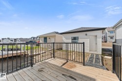 Spacious exterior deck with dark metal railings - 
