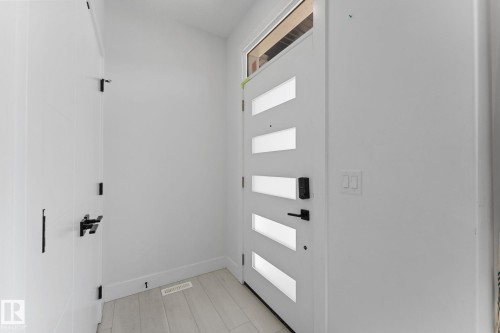 Contemporary entry door with frosted glass inserts and matte black hardware - 3606 42 Avenue, Beaumont, AB 
