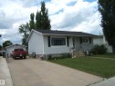 Ranch-style residence featuring light-colored siding and a dark shingle roof - 4606 51 Avenue, Two Hills, AB 