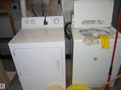 Laundry area featuring a top-load washing machine and a front-load dryer - 4606 51 Avenue, Two Hills, AB 