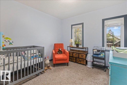 Carpeted room with light blue wall paint and contrasting gray window trim - 3 7210 96 Street, Edmonton, AB - Indoor Photo Showing Bedroom