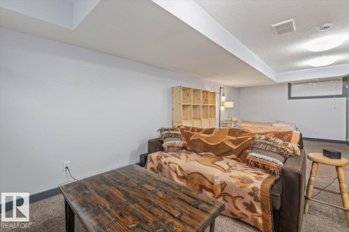 Carpeted room featuring a built-in shelving unit, recessed lighting, and a window with blinds - 3 7210 96 Street, Edmonton, AB - Indoor Photo Showing Bedroom