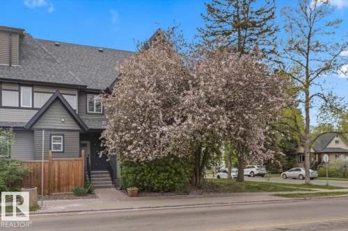 Modern townhome exterior featuring multi-toned siding, a dark pitched roof, and a prominent front gable - 3 7210 96 Street, Edmonton, AB - Outdoor