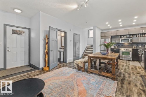 Open concept living space featuring wood-finish flooring - 3 7210 96 Street, Edmonton, AB - Indoor
