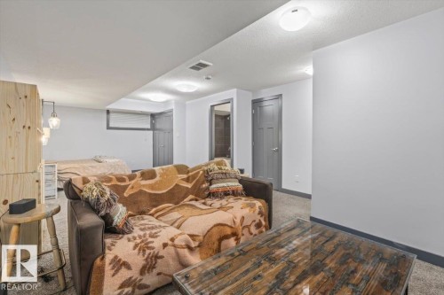 Carpeted recreation room featuring white walls and a textured ceiling - 3 7210 96 Street, Edmonton, AB - Indoor Photo Showing Other Room