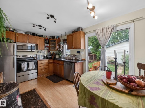Kitchen featuring wood cabinetry and stainless steel appliances - 10809 150 Street, Edmonton, AB 
