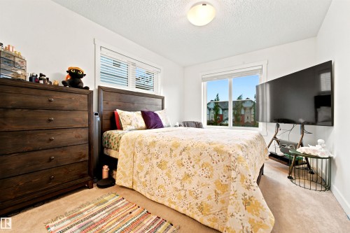 Neutral-toned carpeting extends throughout this space with white walls and trim - 64 655 Watt Boulevard, Edmonton, AB 
