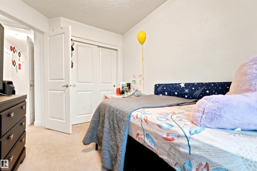 Bedroom featuring light-toned carpeting and white walls - 64 655 Watt Boulevard, Edmonton, AB 