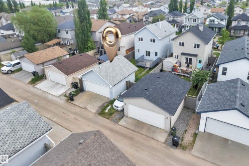 Light blue siding residence featuring a dark shingle roof, attached garage, and a fenced backyard - 2362 29A Avenue, Edmonton, AB 