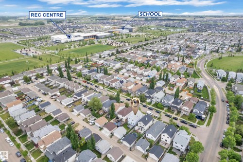 Aerial view of a residential neighborhood with detached homes, including a prominent recreation center and a school within the broader community - 2362 29A Avenue, Edmonton, AB 