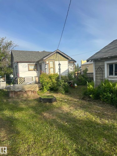 Rear exterior featuring white siding, a contrasting gable, and a gray shingled roof - 5023 50 Street, Vilna, AB - Outdoor