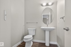 Pedestal sink with oval mirror and overhead light fixture - 