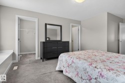 Spacious room featuring neutral paint, gray carpet, a built-in window bench, and a closet with shelving - 